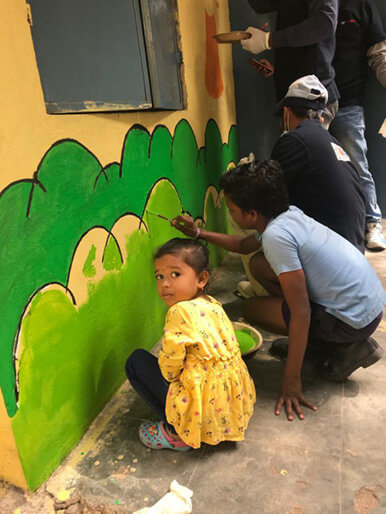TKM Employees taking part in mural painting with school children, as part of the ICARE activity